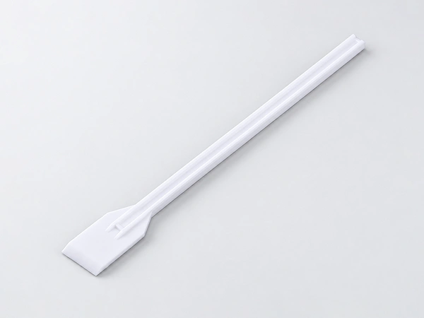 White cell lifter with a long slender handle and a flat, wide paddle-shaped blade.