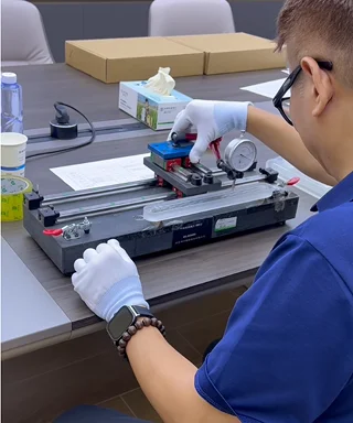 Inspectors perform dimensional inspection on industrial glass