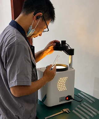 Inspector uses stress testing equipment to check industrial glass
