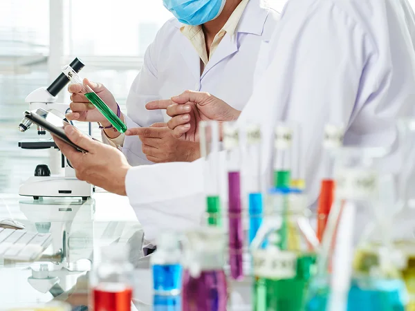 Laboratory specialists working together on an experiment.