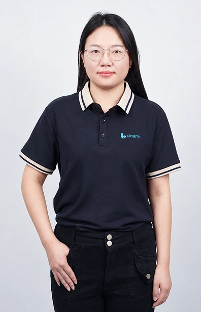 Bella wears a navy uniform and stands with her hands naturally positioned.
