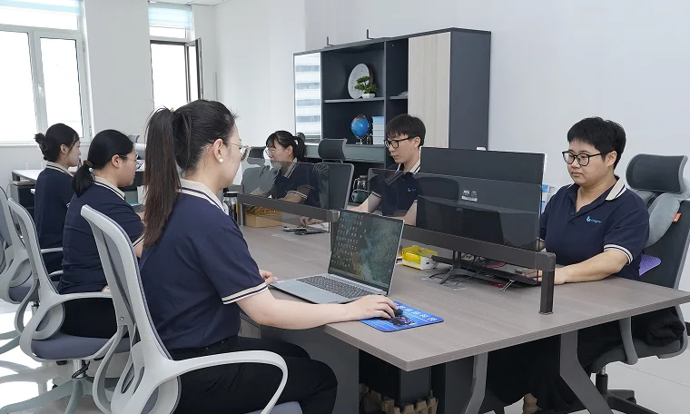 Our staff work diligently at their computers in the office.