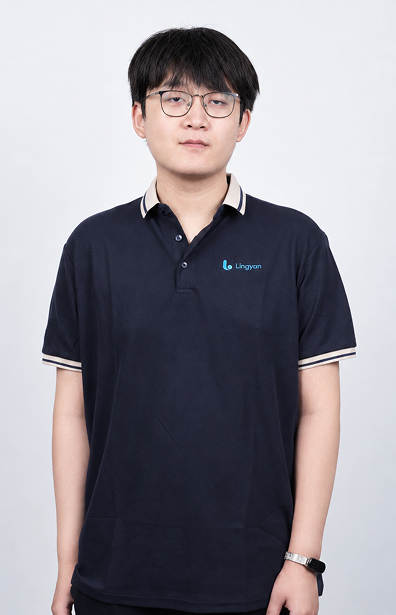 Loren Lee wears a navy uniform and stands with his hands naturally at his sides.