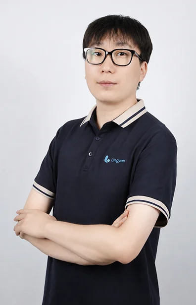 Owen Li is standing with his arms crossed.
