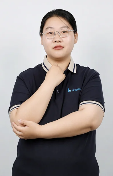 Vivian is standing with her arms crossed.