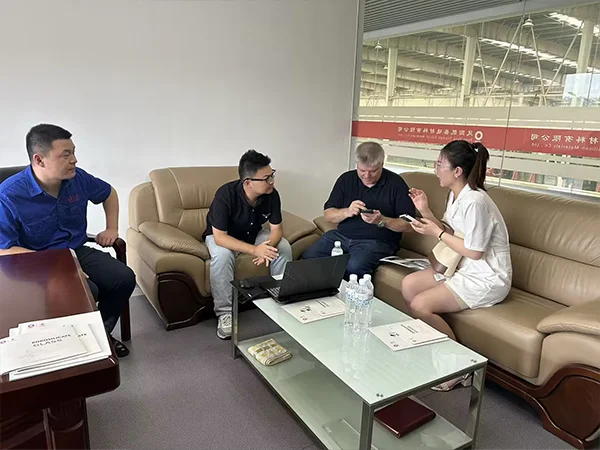 Our representative discusses product and supply details with the customer and factory team.