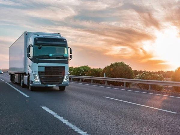 A freight truck transports goods on a highway during delivery.