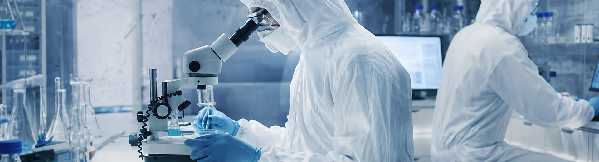 Laboratory technicians use microscopes and laboratory equipment for testing and life science research.