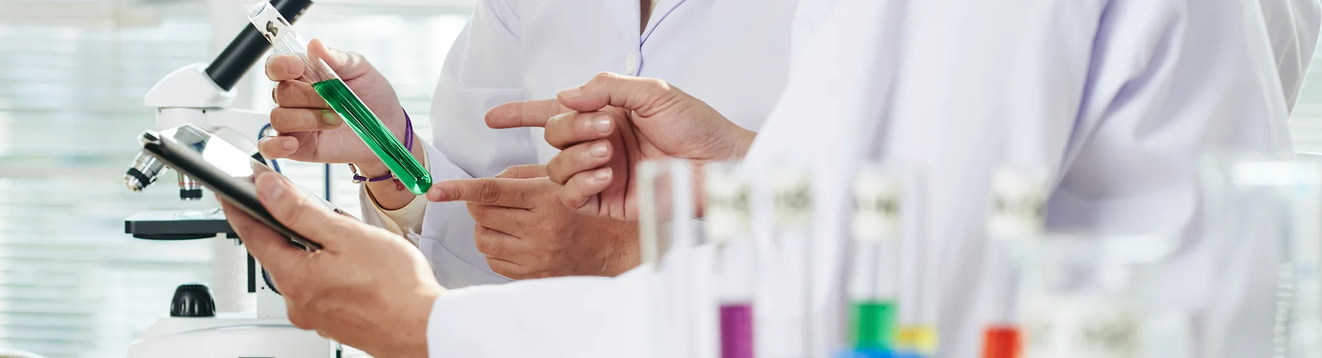 Laboratory staff examine samples and discuss results.